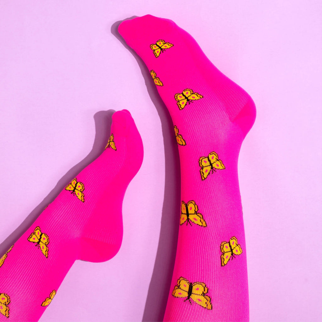 Pink compression socks with butterfly pattern