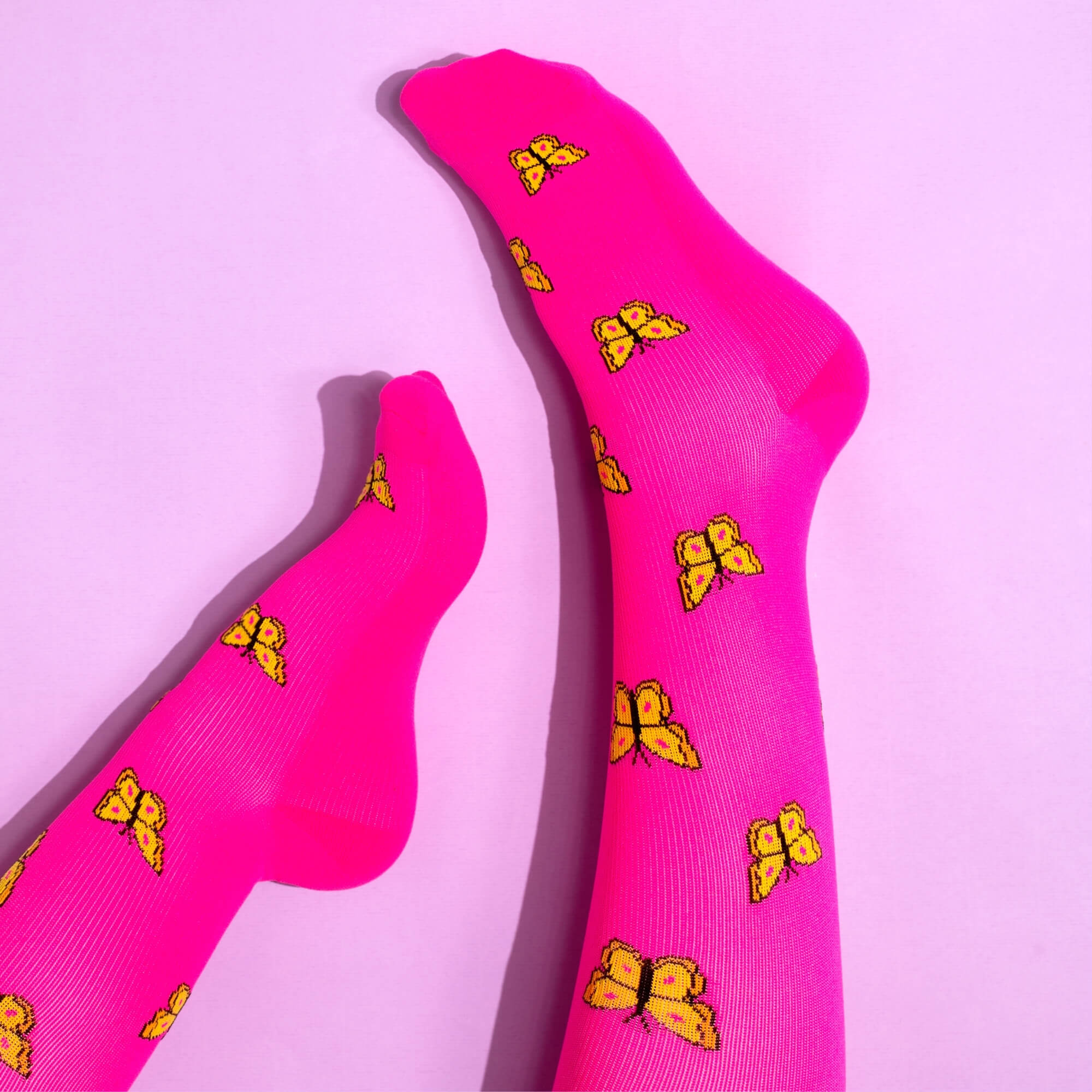 Pink compression socks with butterfly pattern
