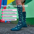 Model wearing green compression socks with a dinosaur pattern legs only.