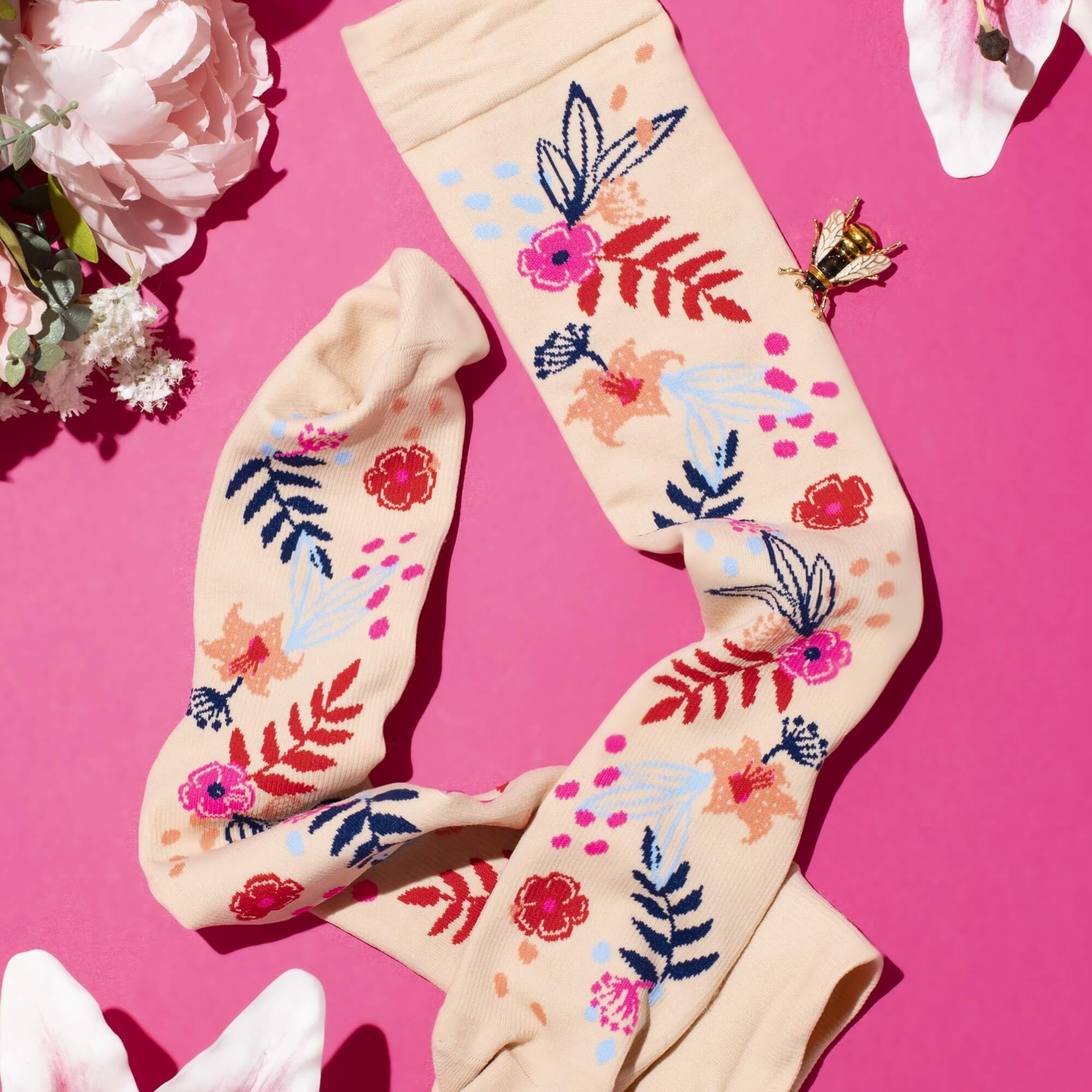 Floral-patterned compression socks with flower decorations around them