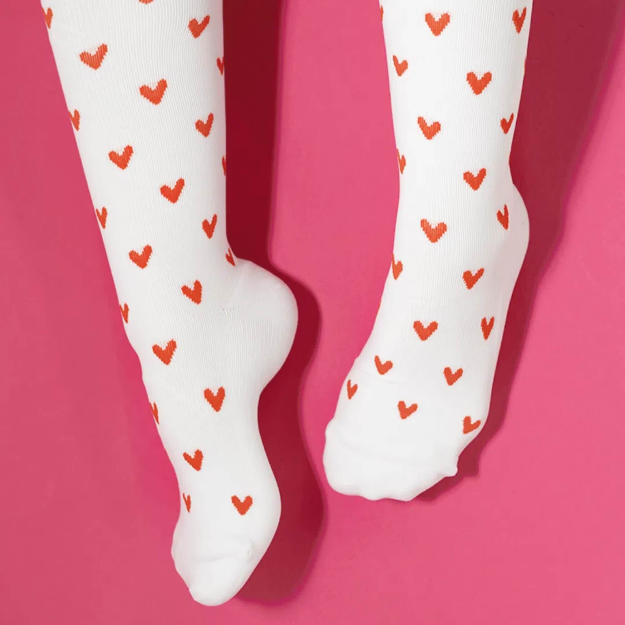 White compression socks with red heart patterns