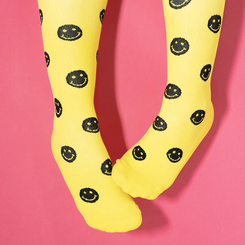 Yellow compression socks with black smiley faces
